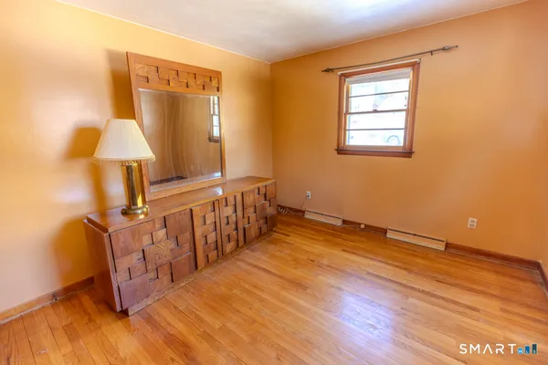 a view of hallway with wooden floor