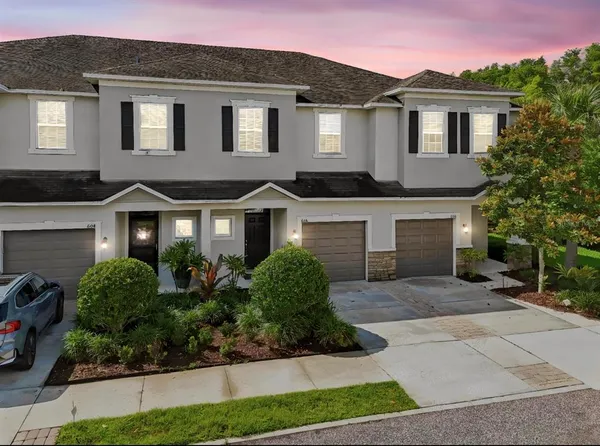 a front view of a house with a yard and garage