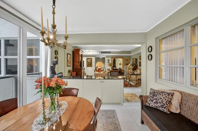 a living room with furniture chandelier and wooden floor