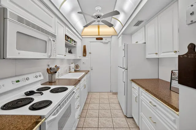 a kitchen with a sink a stove and refrigerator