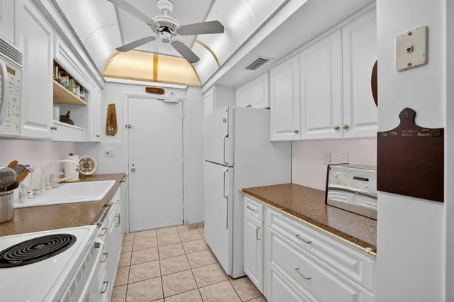 a kitchen with stainless steel appliances granite countertop a sink and cabinets