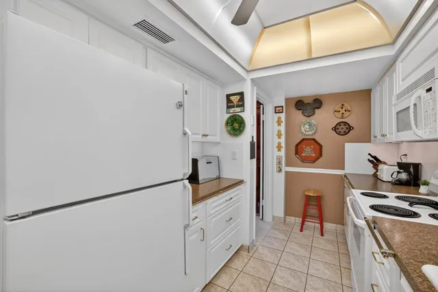 a kitchen with stainless steel appliances a refrigerator and a stove top oven