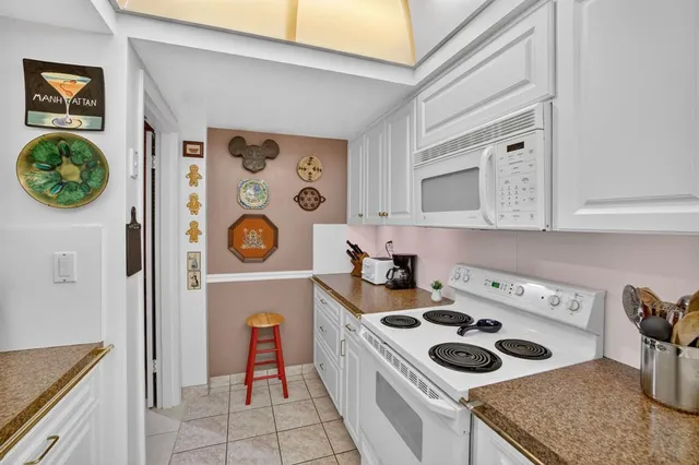 a kitchen with a stove and a white refrigerator