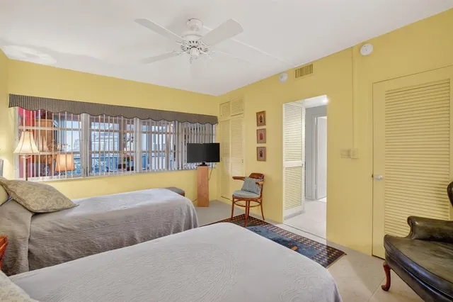 a spacious bedroom with a large bed and a couch