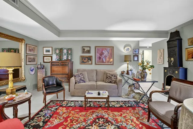 a living room with furniture a rug and a bookshelf