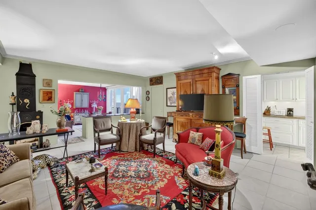 a living room with furniture a rug and a flat screen tv