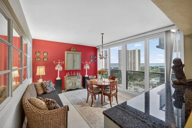 a living room with furniture and a floor to ceiling window