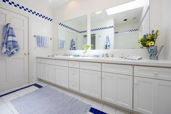 a spacious bathroom with a double vanity sink mirror and next to a window