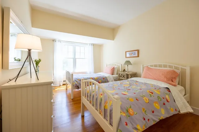 a bedroom with two beds and a window