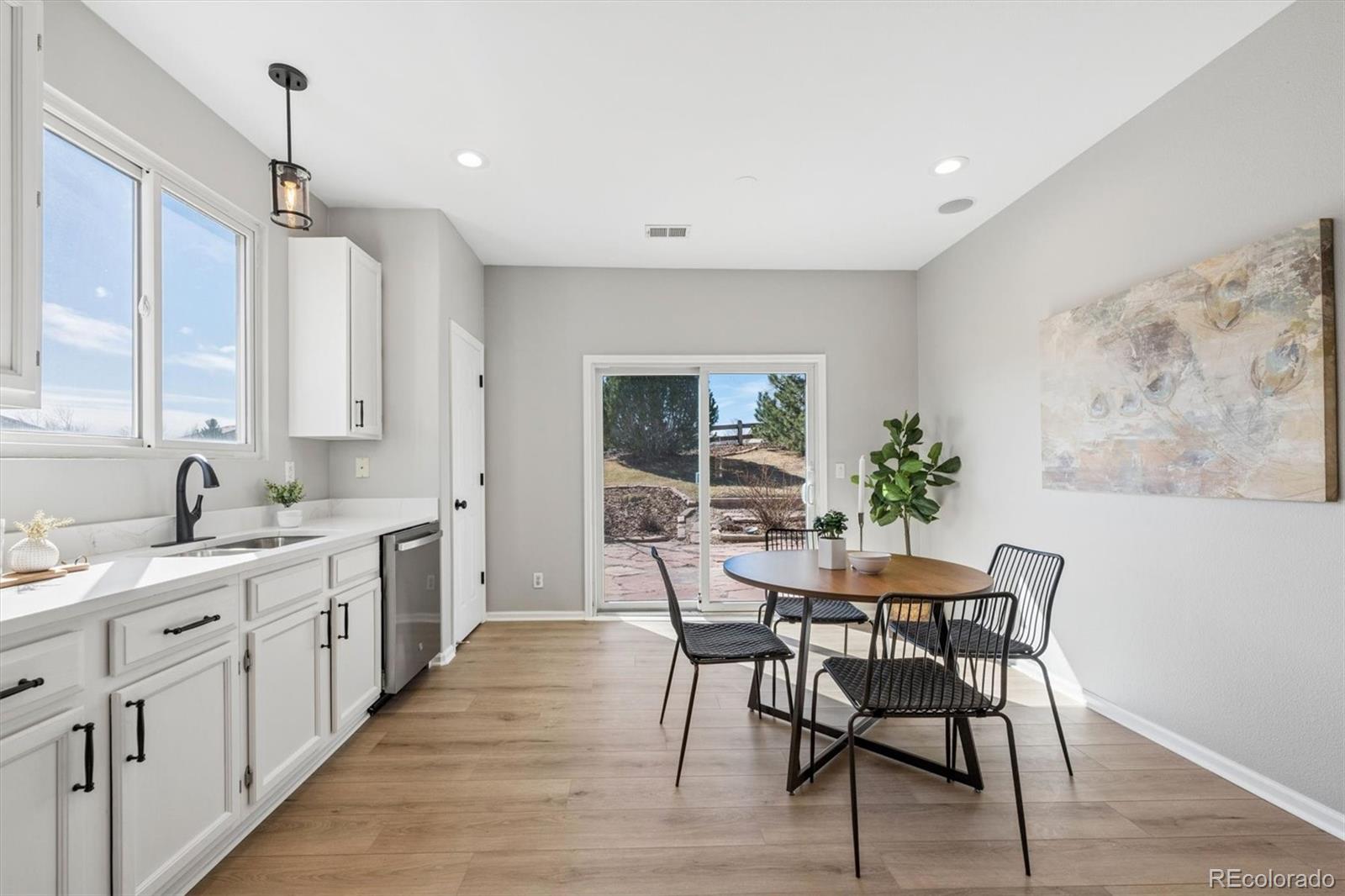 10098 MacKay Drive Highlands Ranch, CO 80130 - Photo 13 of 42 a view of a kitchen area with furniture and wooden floor