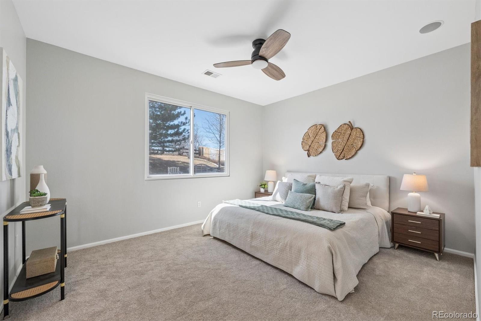 10098 MacKay Drive Highlands Ranch, CO 80130 - Photo 17 of 42 a bedroom with bed and a night stand