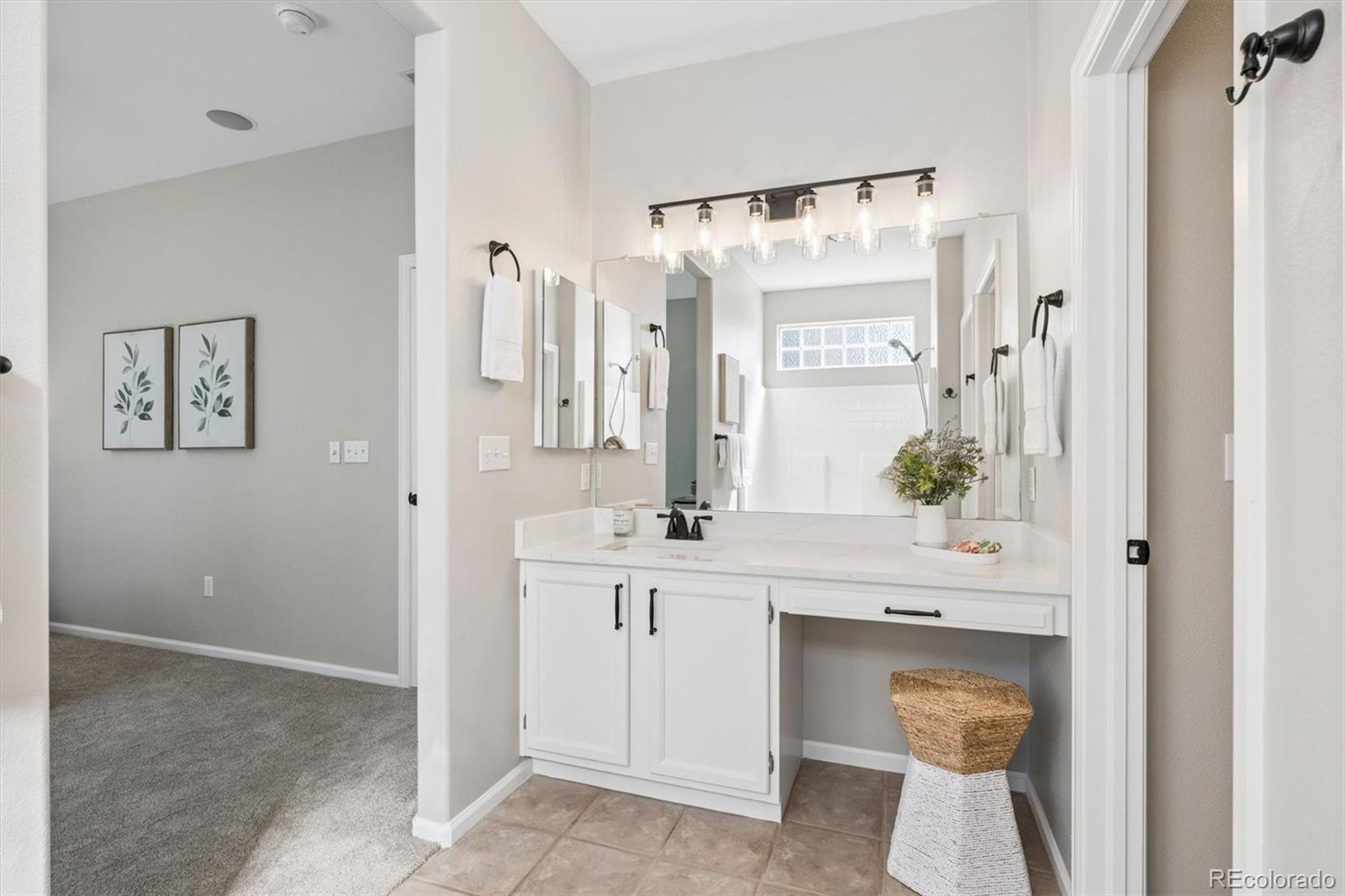 10098 MacKay Drive Highlands Ranch, CO 80130 - Photo 20 of 42 a spacious bathroom with a granite countertop sink and a mirror