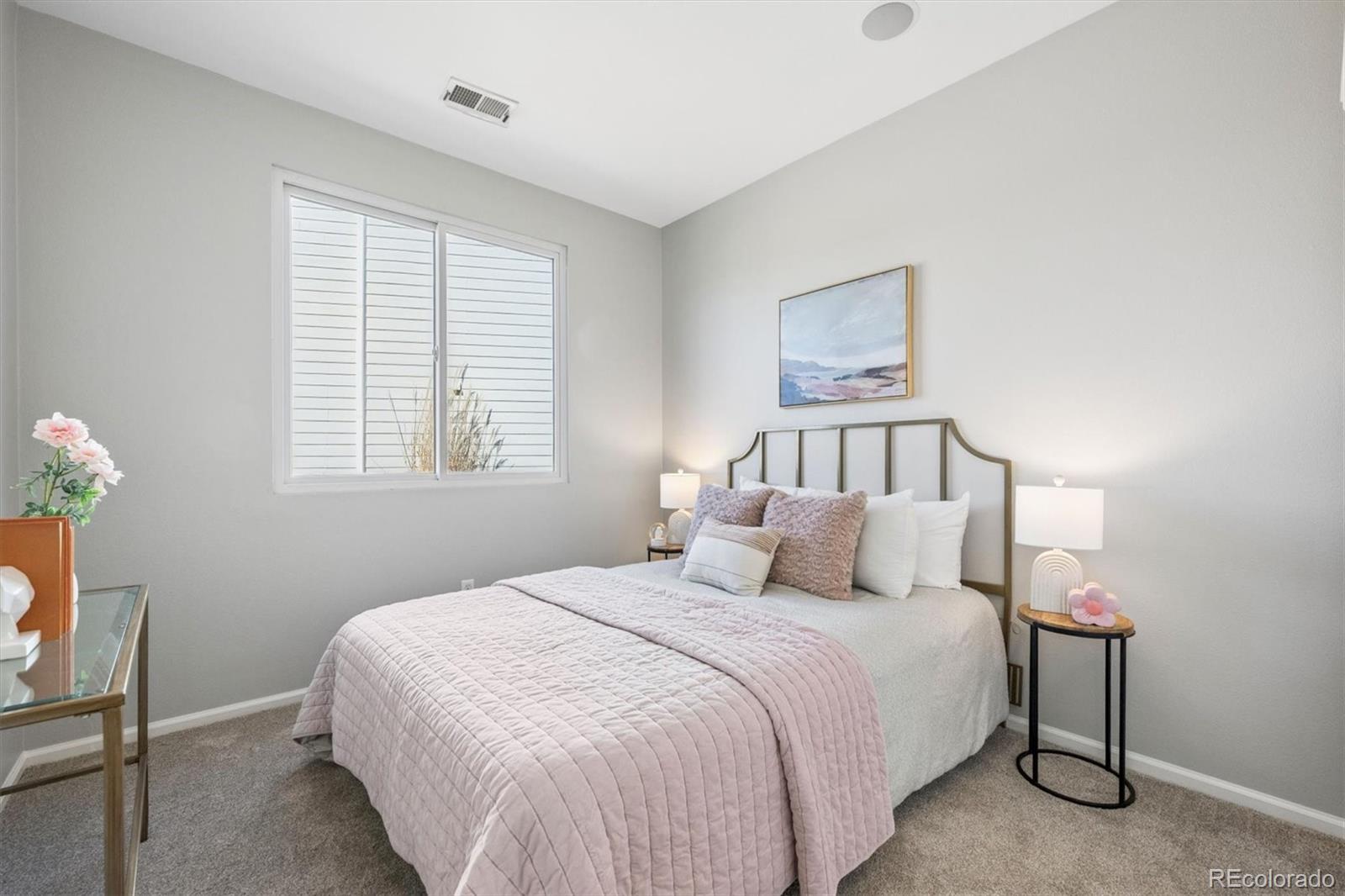 10098 MacKay Drive Highlands Ranch, CO 80130 - Photo 22 of 42 a bedroom with a bed and a window