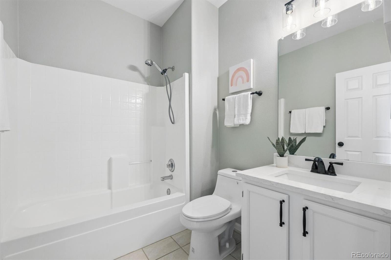 10098 MacKay Drive Highlands Ranch, CO 80130 - Photo 23 of 42 a bathroom with a sink toilet and shower