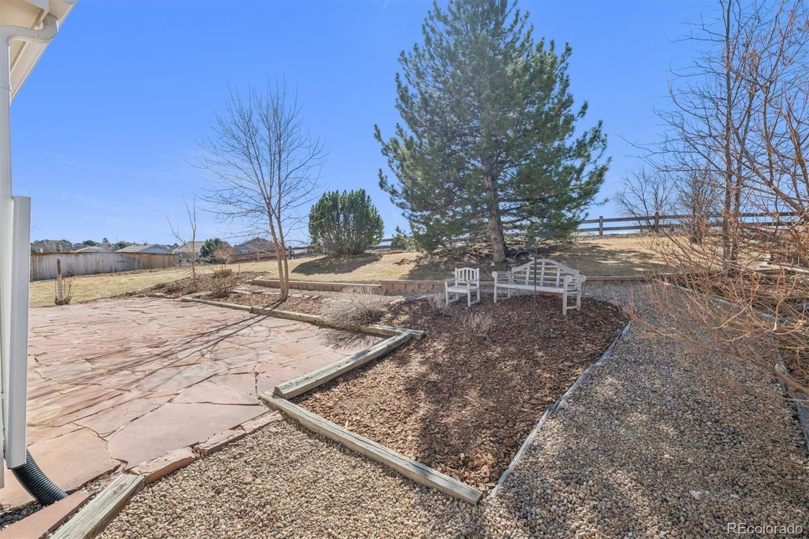 10098 MacKay Drive Highlands Ranch, CO 80130 - Photo 25 of 42 a view of a yard with trees