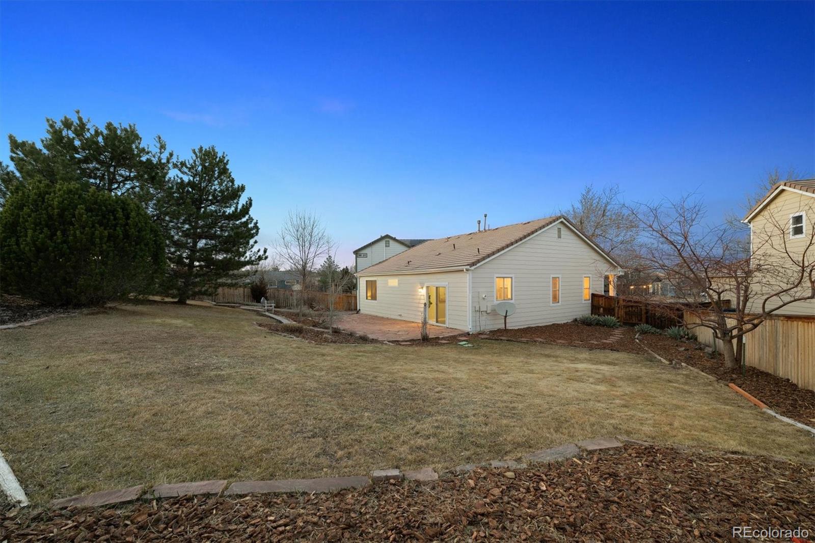 10098 MacKay Drive Highlands Ranch, CO 80130 - Photo 31 of 42 a view of a house with a yard