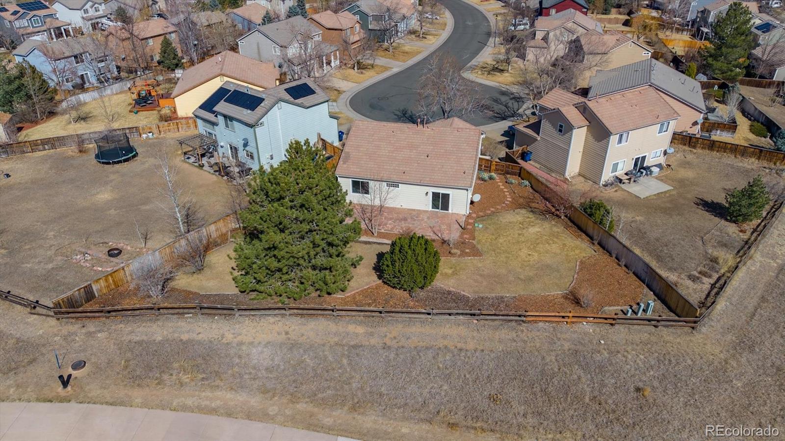 10098 MacKay Drive Highlands Ranch, CO 80130 - Photo 32 of 42 an aerial view of a house with a yard and a garage