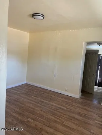 a view of a room with wooden floor