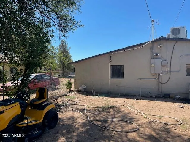 a backyard of a house with yard and outdoor seating