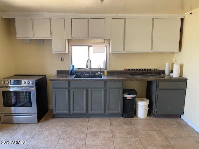 1206 5th Street Douglas, AZ 85607 - Photo 6 of 15 a kitchen with stainless steel appliances granite countertop a stove a sink and a white cabinets