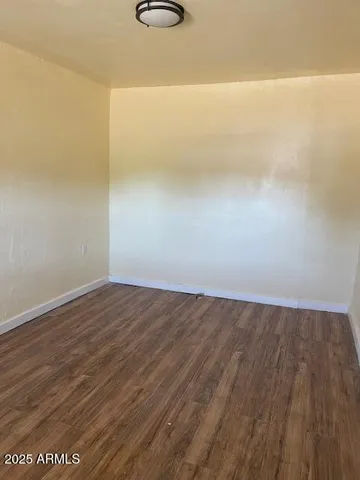 a view of a room with wooden floor