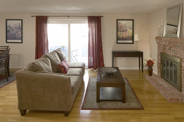 1 Circuit Lane, Unit D Watertown, MA 02472 - Photo 2 of 4 a living room with furniture and a fireplace