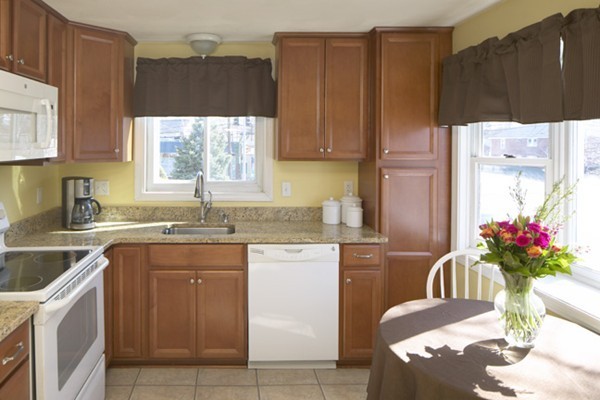 1 Circuit Lane, Unit D Watertown, MA 02472 - Photo 3 of 4 a kitchen with a sink refrigerator and cabinets