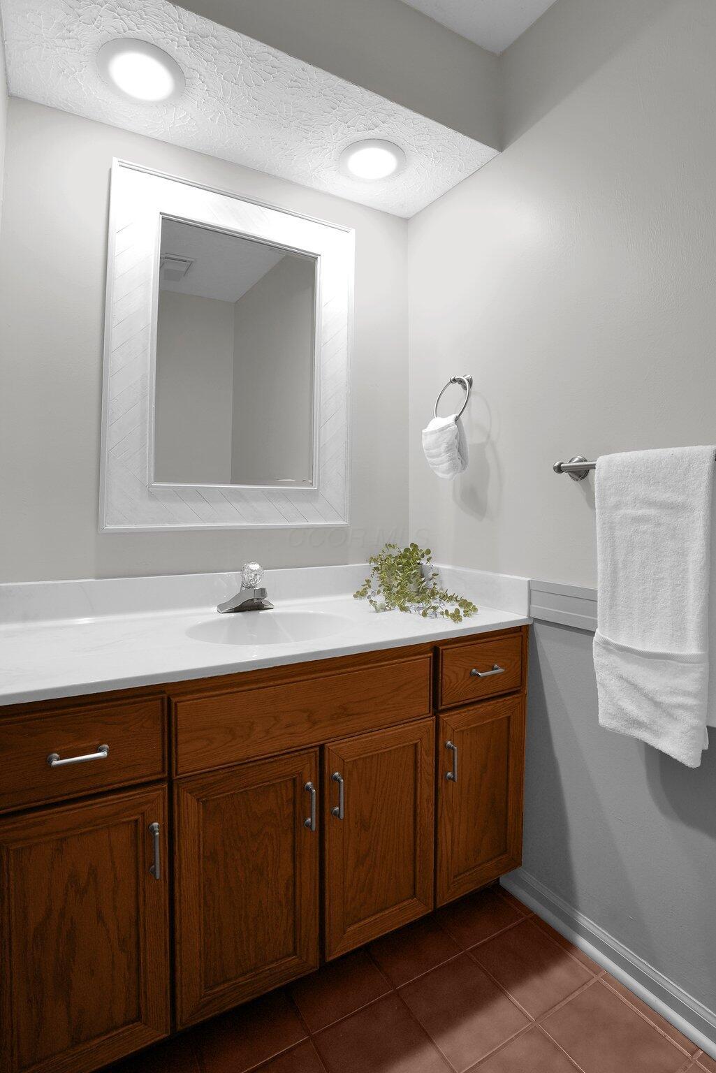 623 Rockbridge Road Westerville, OH 43081 - Photo 23 of 63 Updated first floor powder room has neutral vanity top cool gray color scheme, and new mirror.