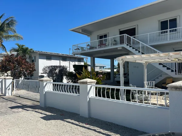 a view of a white building among the front of a house