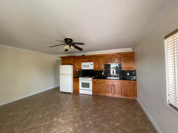 a kitchen with stainless steel appliances granite countertop a sink and a stove