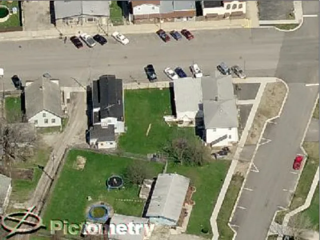 an aerial view of a residential houses with outdoor space