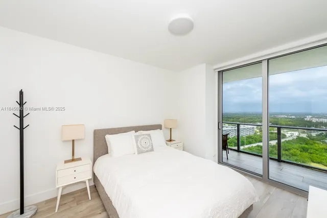 a bedroom with a bed and a large window