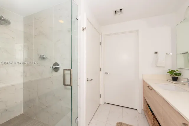 a bathroom with a shower and a sink