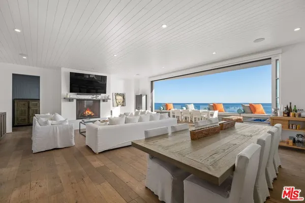a living room with fireplace furniture and a flat screen tv