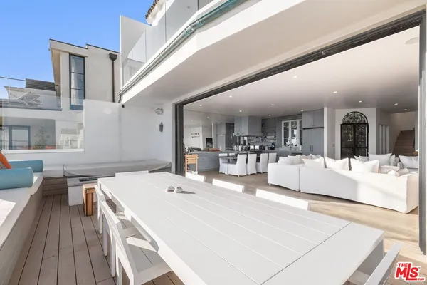 a large white kitchen with a large window and counter top