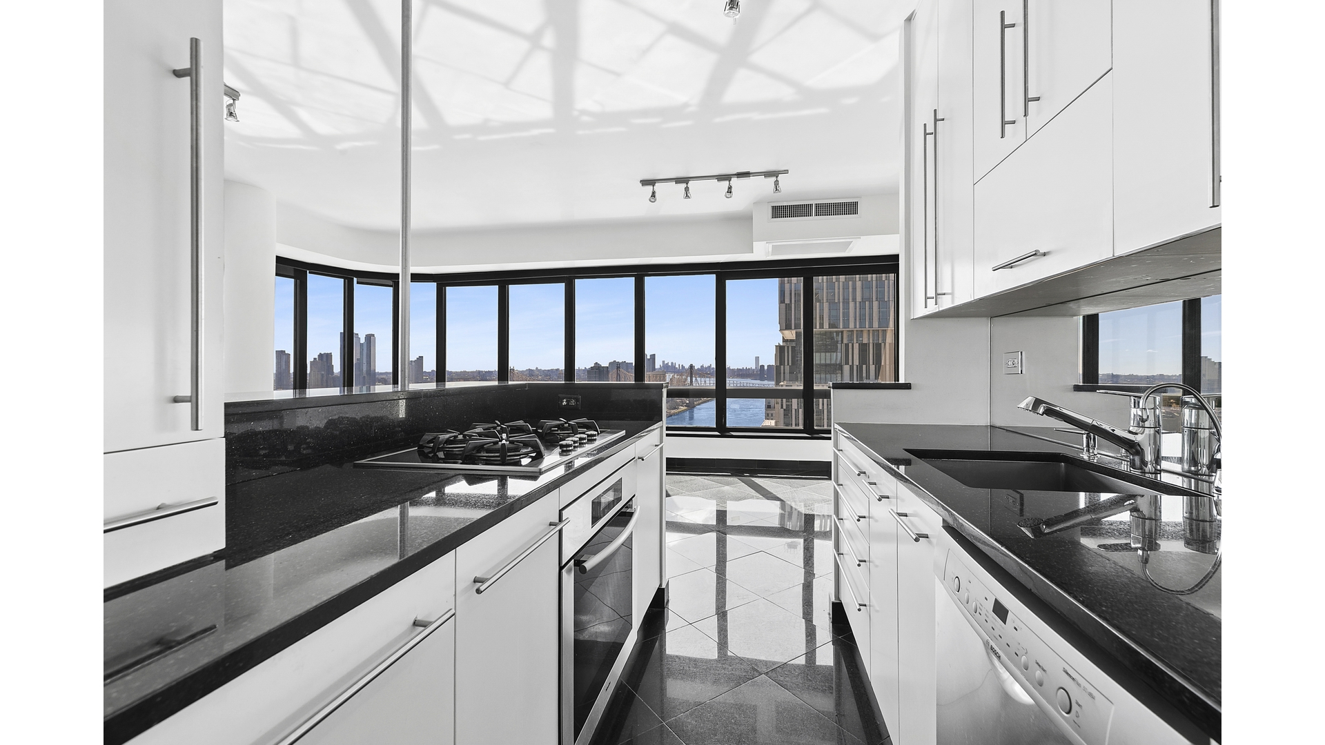 530 East 76th Street, Unit 33H Manhattan, NY 10021 - Photo 5 of 10 a kitchen with stainless steel appliances granite countertop a stove and a refrigerator