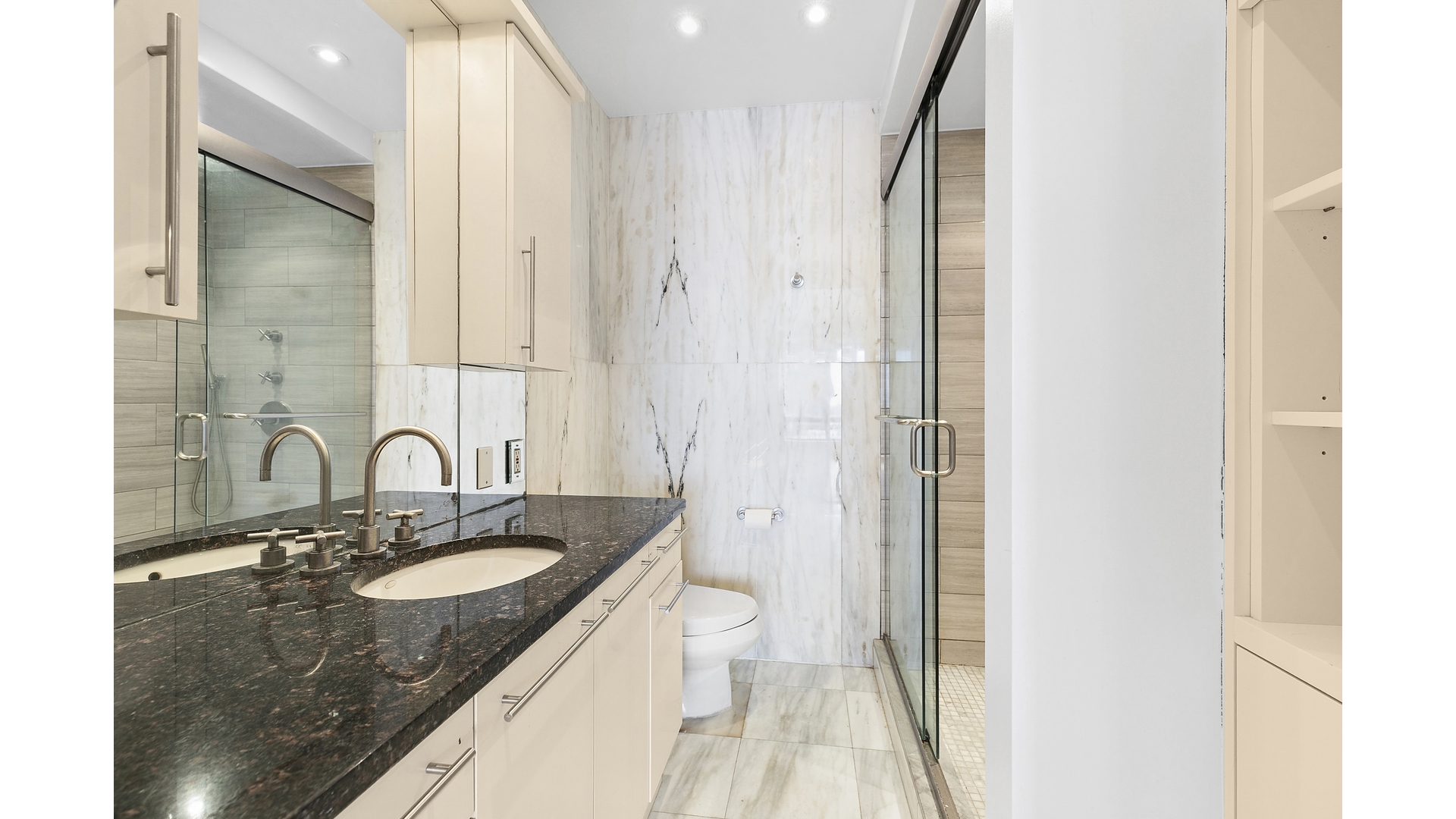 530 East 76th Street, Unit 33H Manhattan, NY 10021 - Photo 7 of 10 a bathroom with a granite countertop sink a toilet and shower