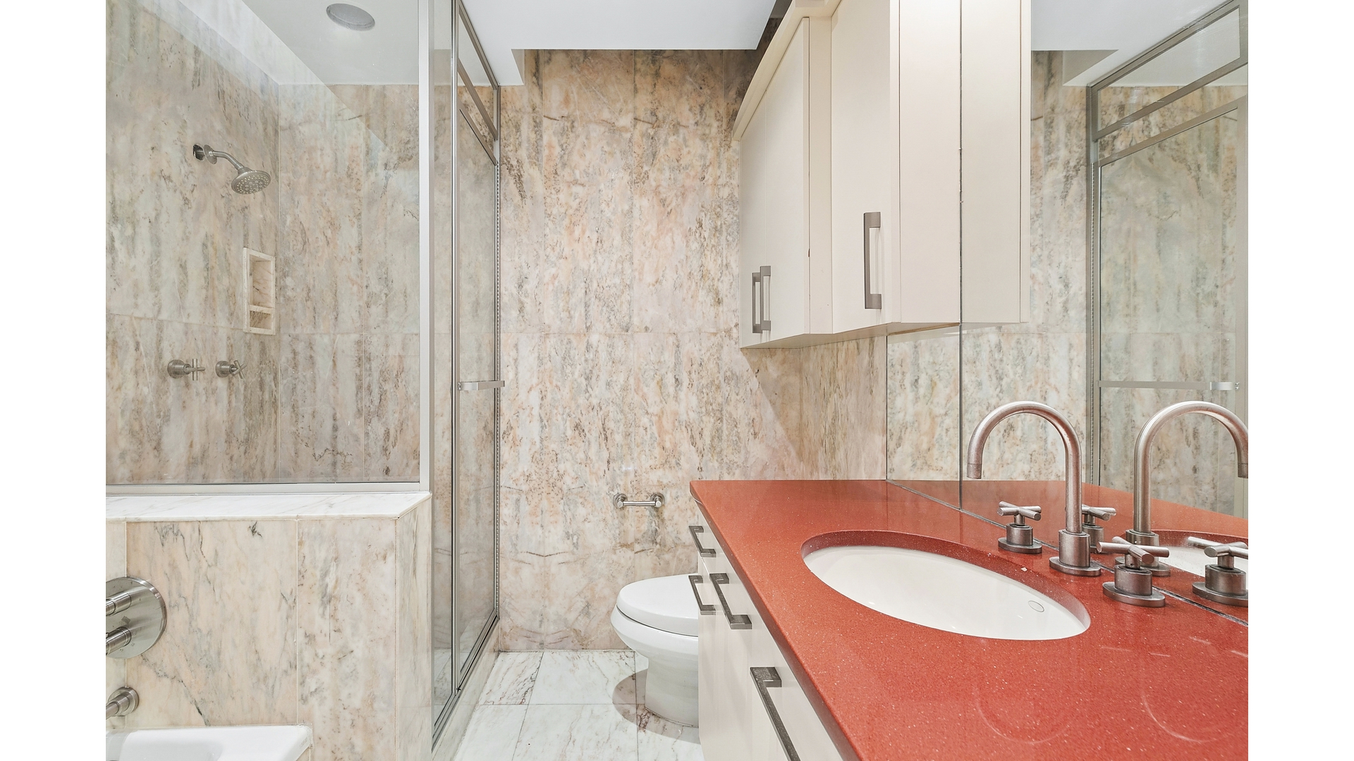 530 East 76th Street, Unit 33H Manhattan, NY 10021 - Photo 9 of 10 a bathroom with a sink and a mirror