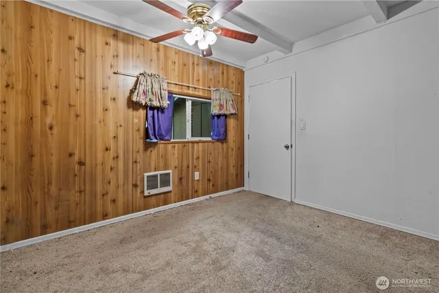 a view of an empty room with a fan