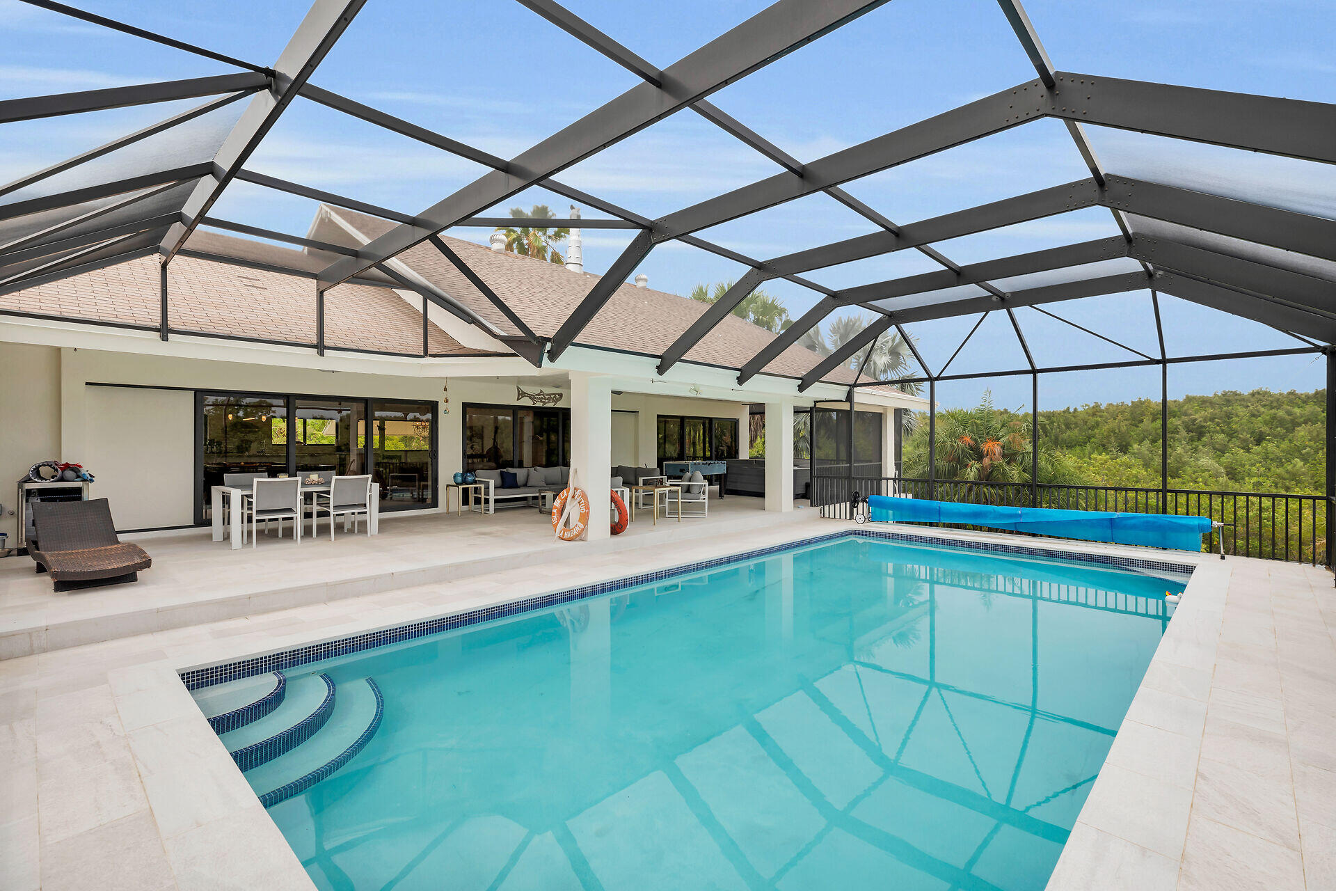31 South Carysfort Circle Key Largo, FL 33037 - Photo 11 of 47 a view of a patio with a table and chairs under an umbrella
