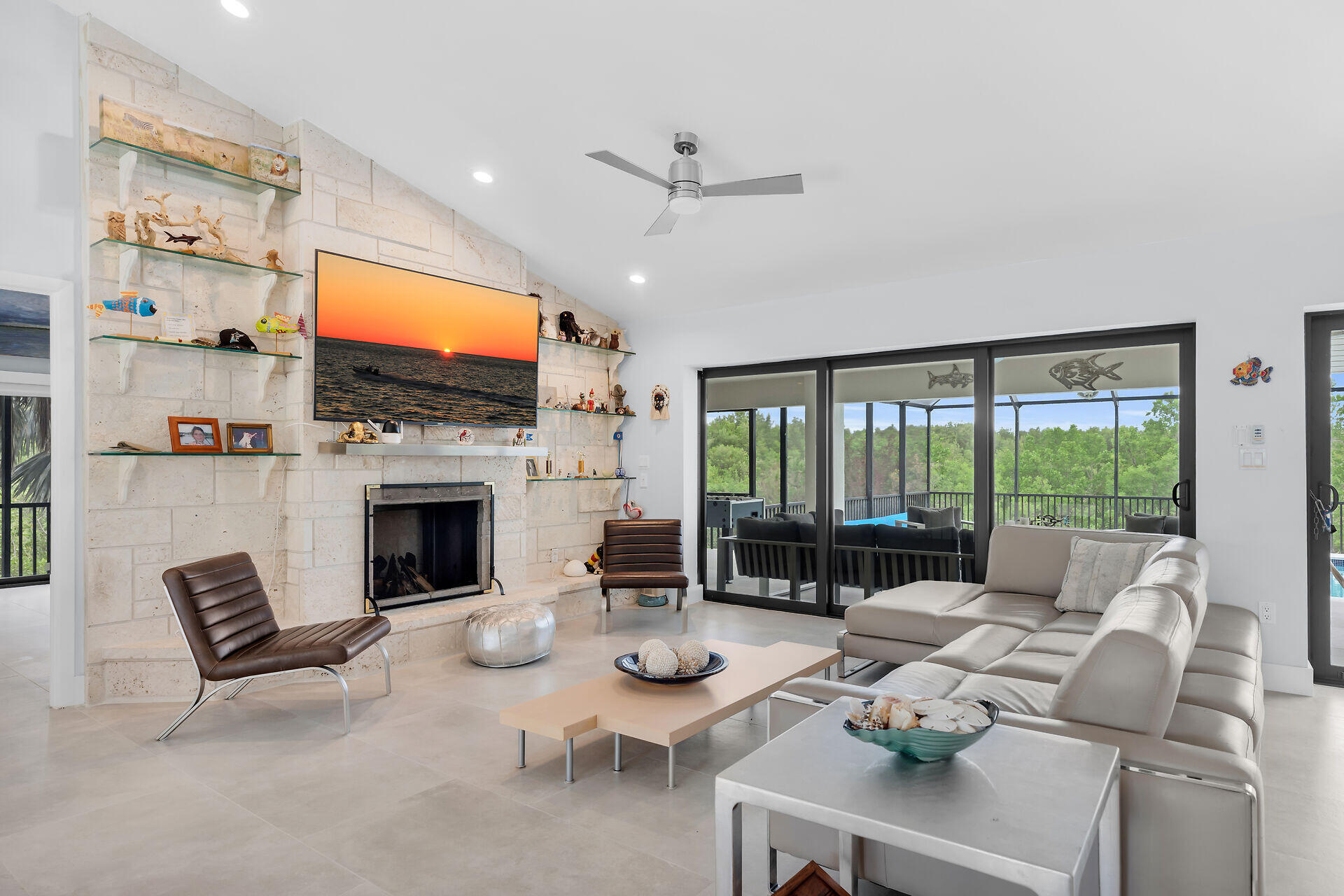 31 South Carysfort Circle Key Largo, FL 33037 - Photo 17 of 47 a living room with furniture a fireplace and a flat screen tv