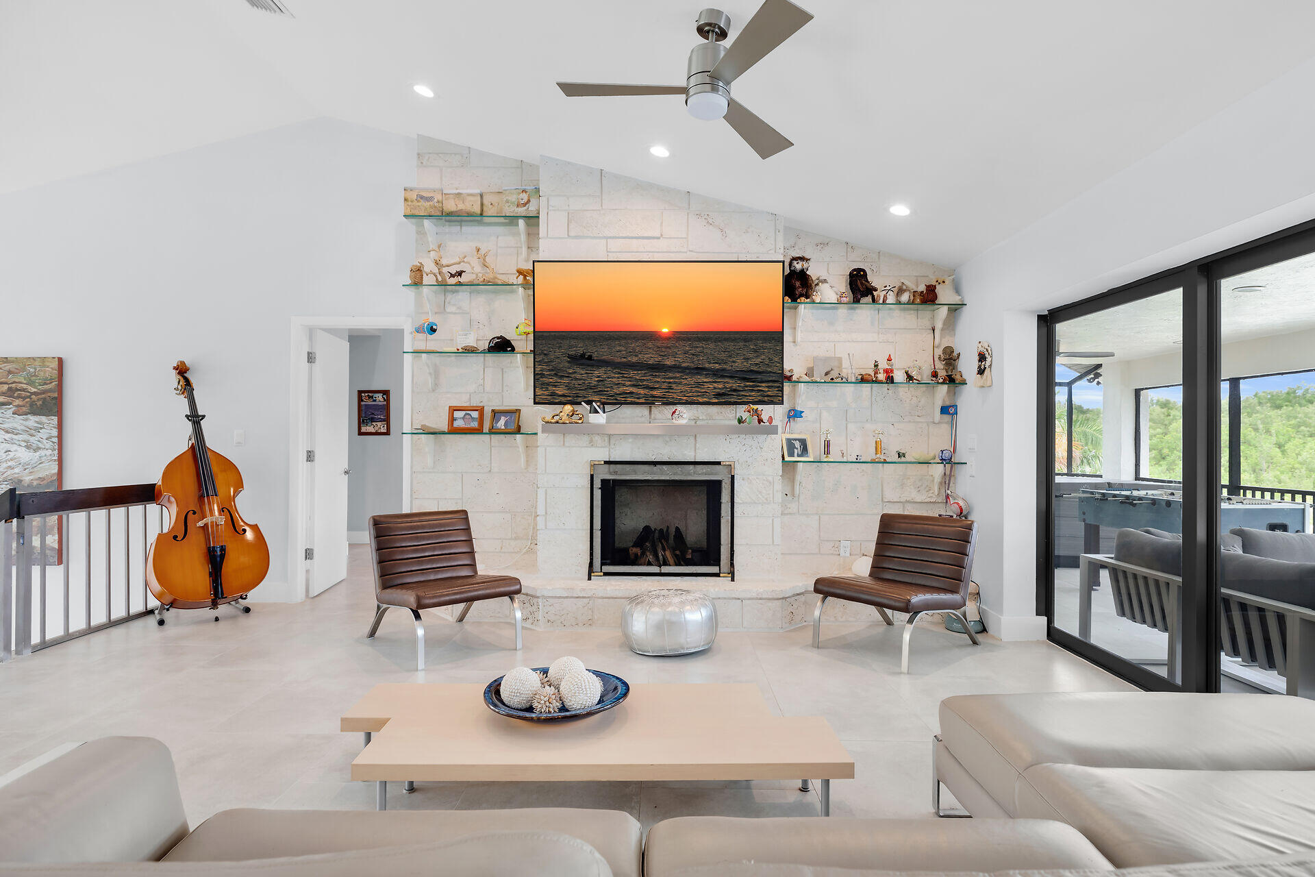 31 South Carysfort Circle Key Largo, FL 33037 - Photo 25 of 47 a living room with furniture a flat screen tv and a fireplace
