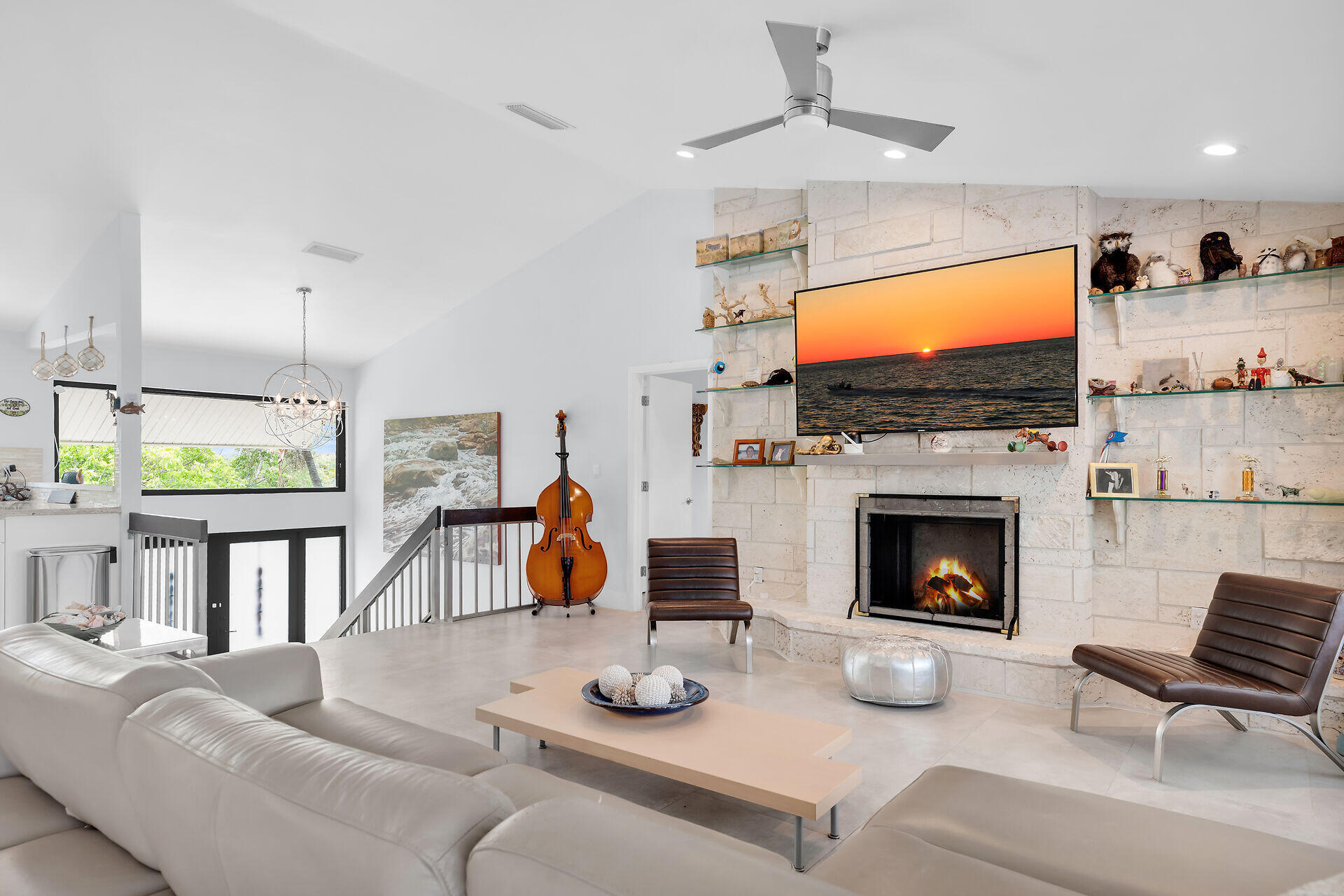 31 South Carysfort Circle Key Largo, FL 33037 - Photo 26 of 47 a living room with furniture a flat screen tv and a fireplace