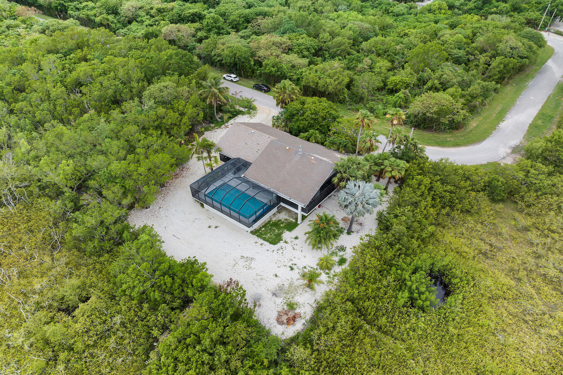 31 South Carysfort Circle Key Largo, FL 33037 - Photo 7 of 47 an aerial view of a house with a yard and trees