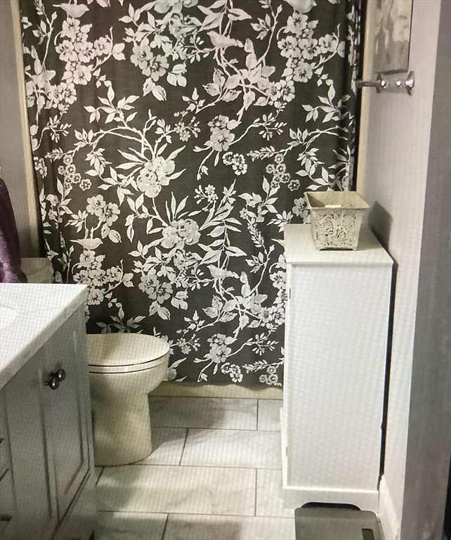 340 Trailside Way, Unit 340 Ashland, MA 01721 - Photo 26 of 39 a white toilet sitting next to a shower curtain