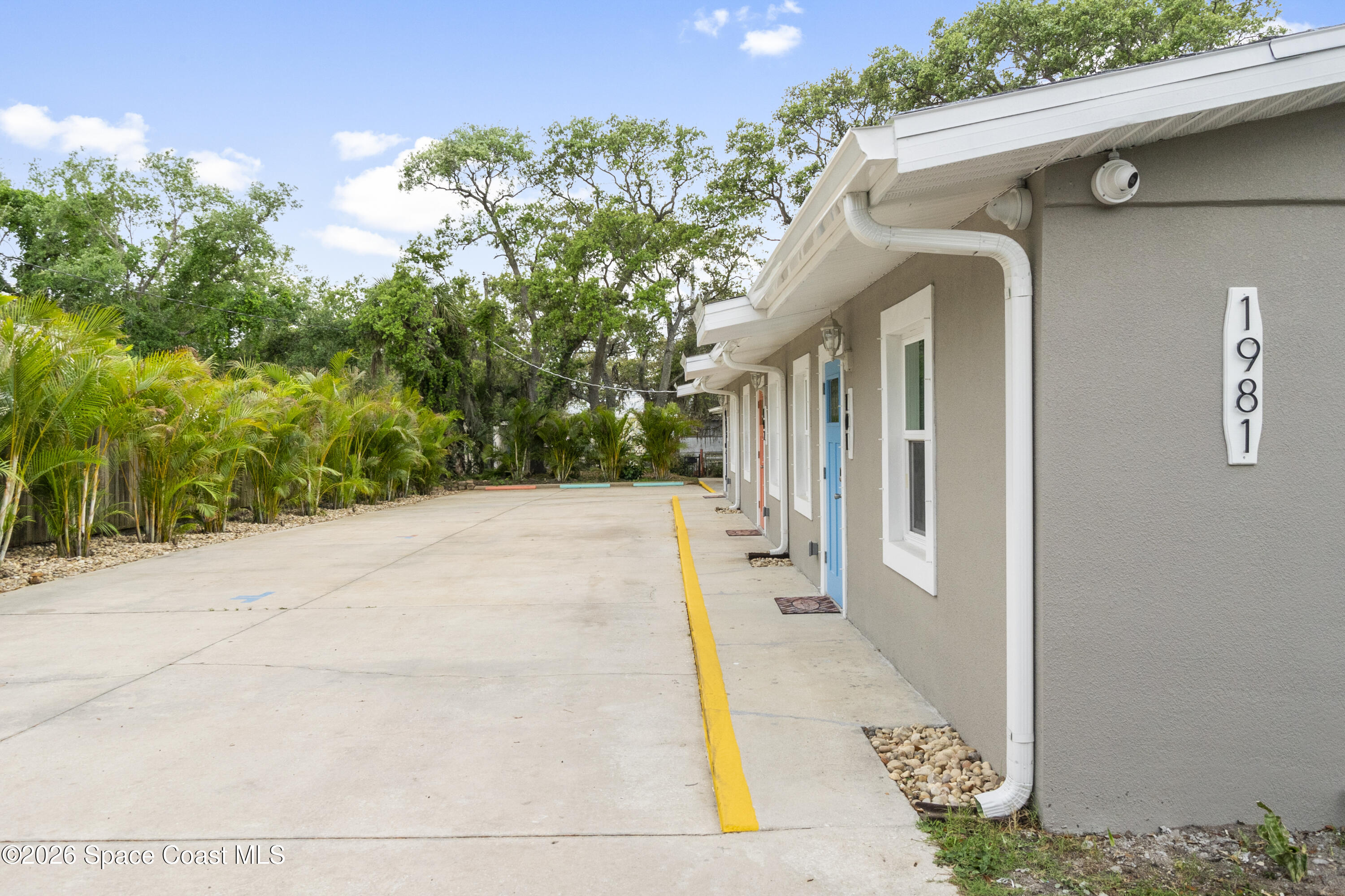 1981 Guava Avenue, Unit 104 Melbourne, FL 32935 - Photo 18 of 20 a view of a house with a backyard