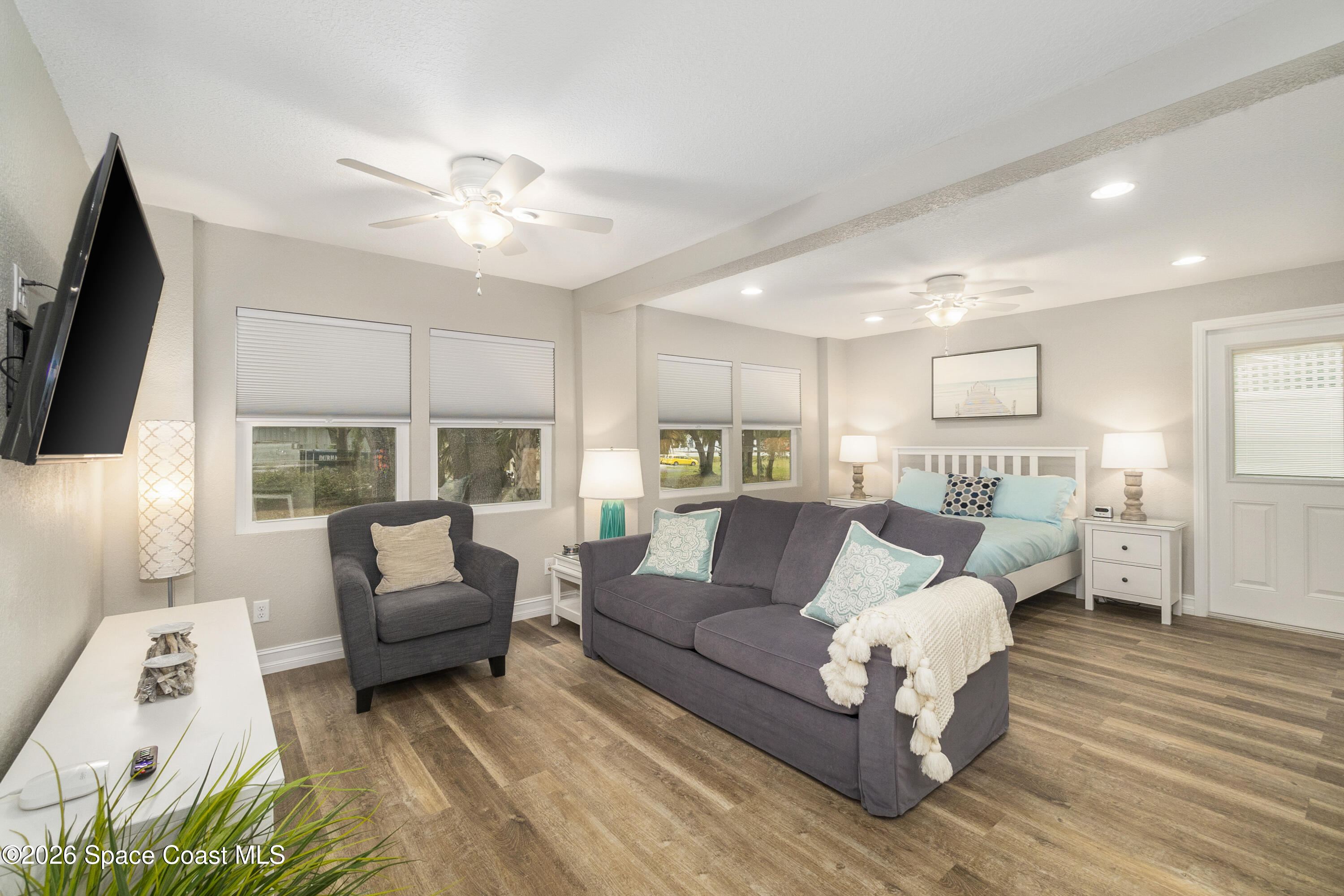 1981 Guava Avenue, Unit 104 Melbourne, FL 32935 - Photo 2 of 20 a living room with furniture and a flat screen tv