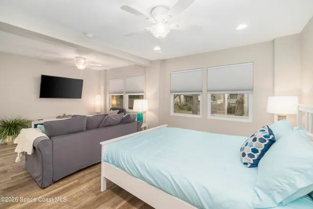 a bedroom with a bed a couch and a window