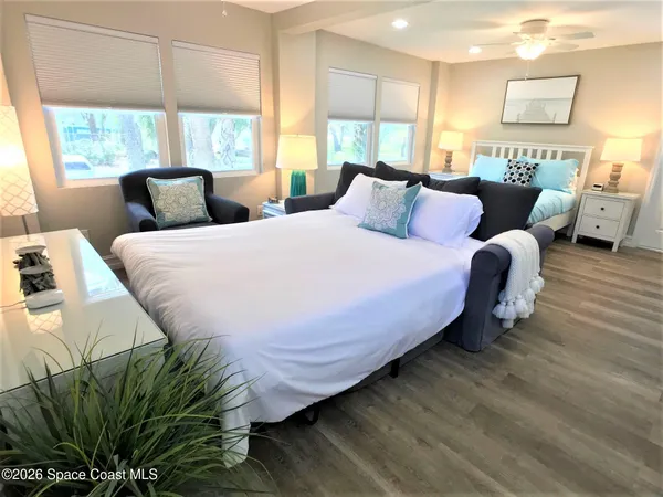 a bedroom with bed and window