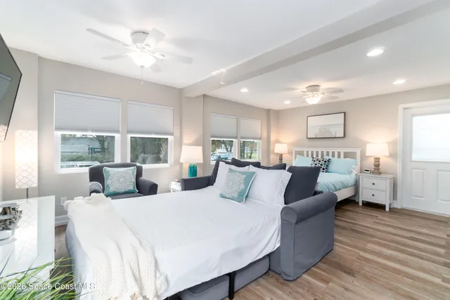 a bedroom with two beds and a large mirror